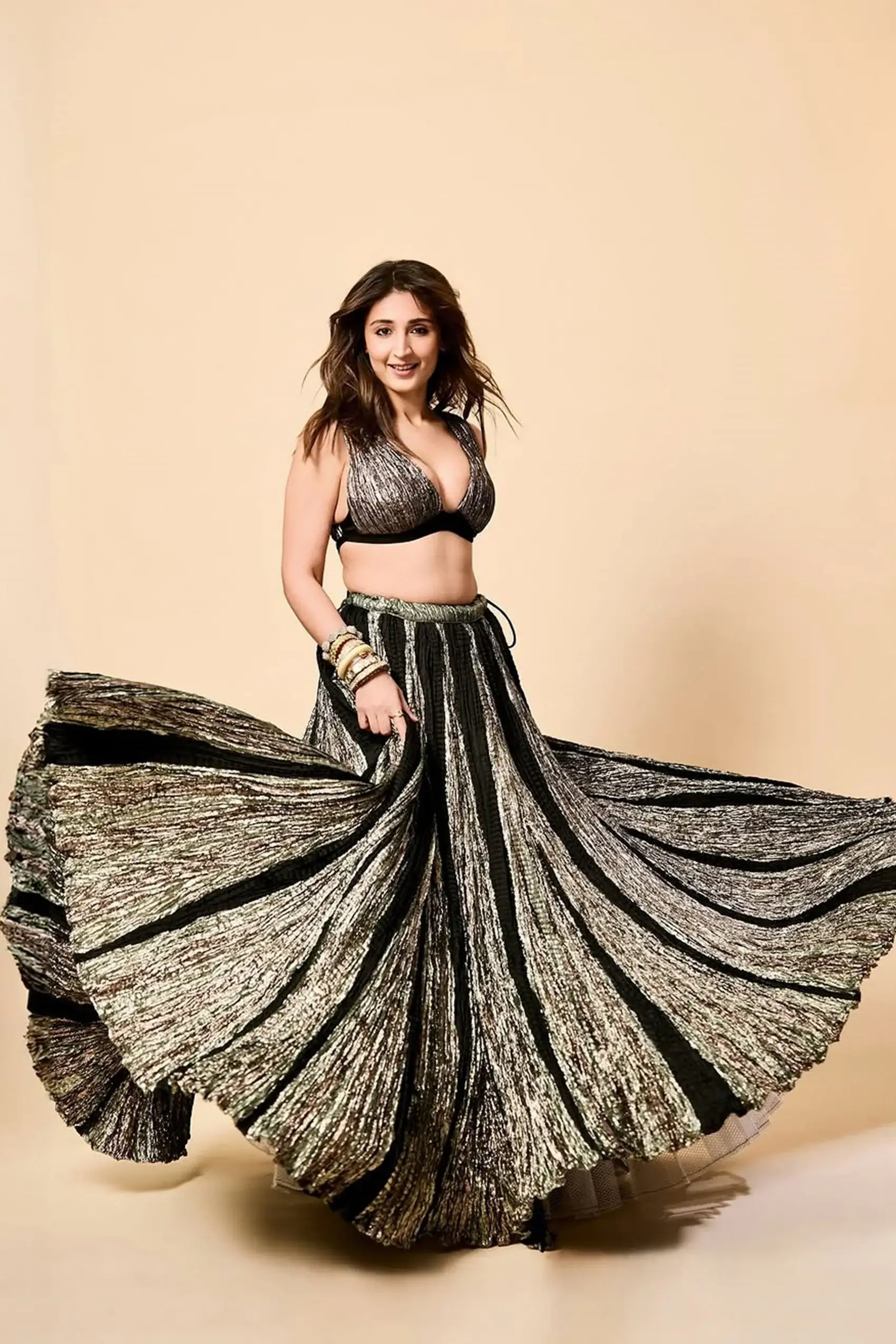Dhvani Bhanushali in a Gunmetal and black metallic lehenga and busiter set