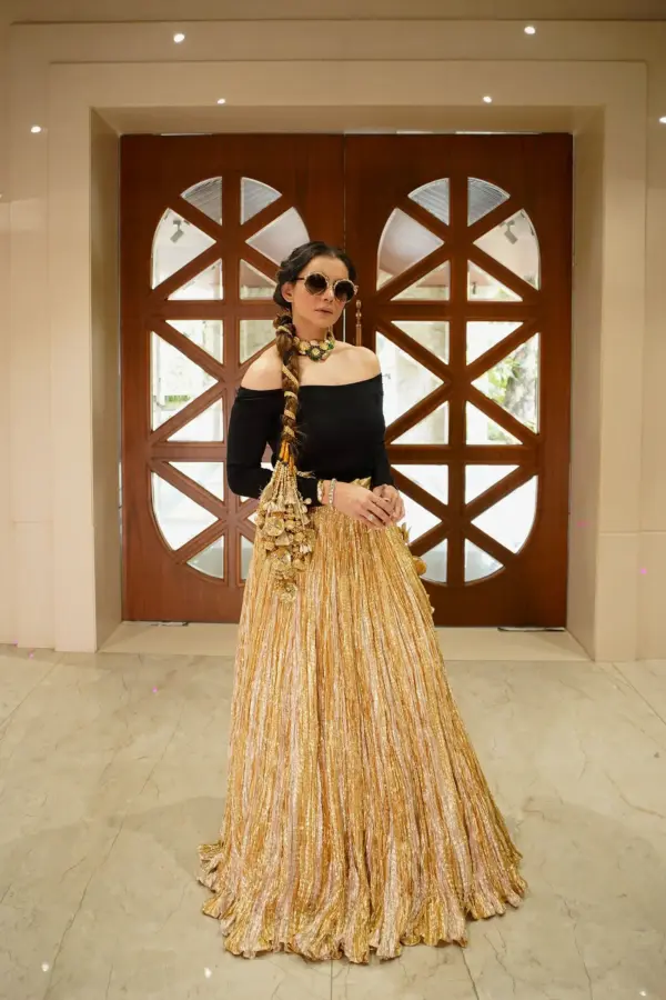 Tanya Kapoor in a gold metallic lehenga off shoulder blouse