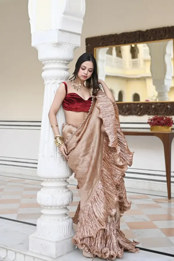 Nitanshi Goel in a Champagne tissue and metallic saree