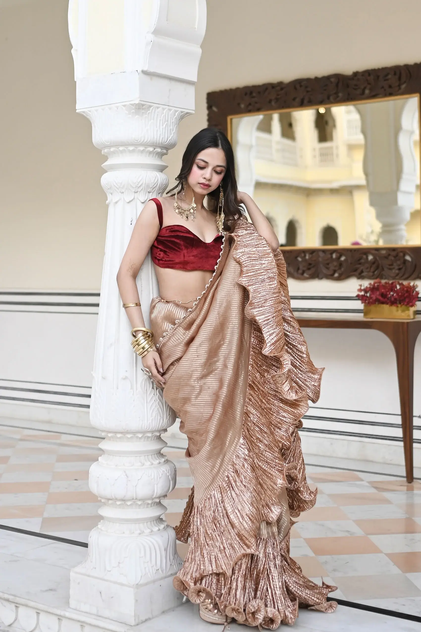 Nitanshi Goel in a Champagne tissue and metallic saree