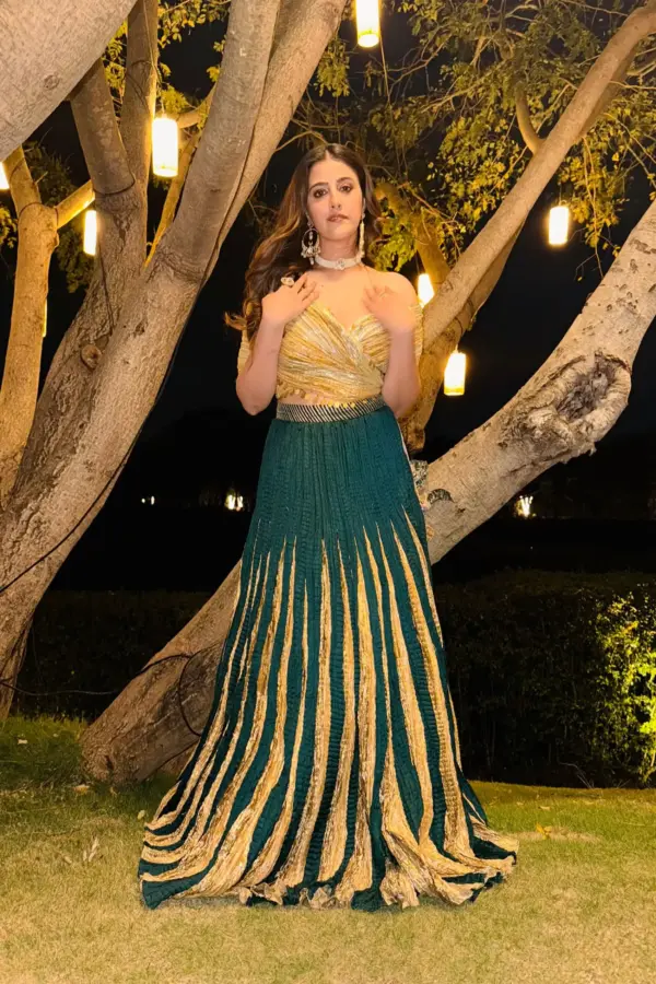Nupur Sanon in bottle green lehenga with wrap around metallic blouse
